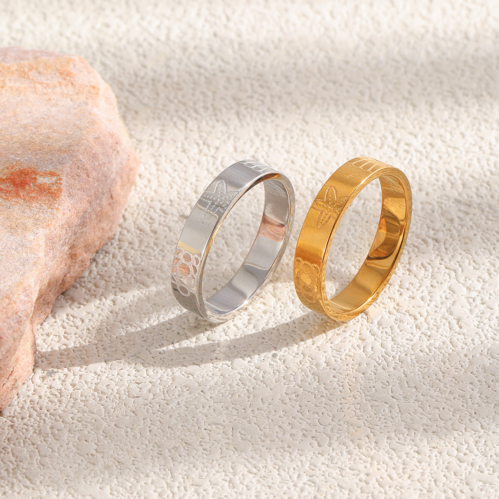 Two marine-patterned ring finishes shown upright