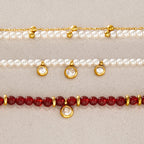 Red and white beaded bracelet details with clear round drops