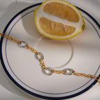 Alternating link bracelet beside a lemon