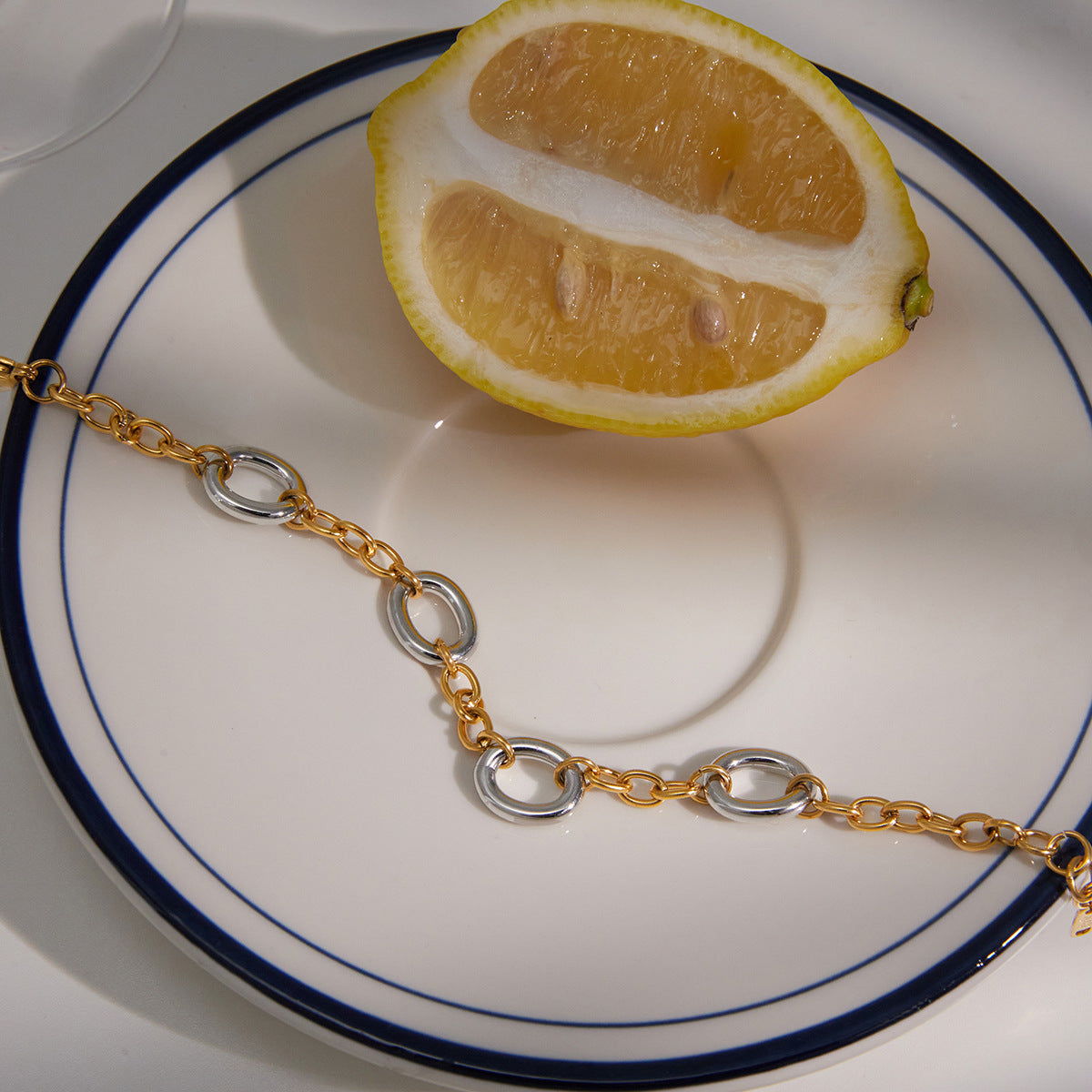 Alternating link bracelet beside a lemon