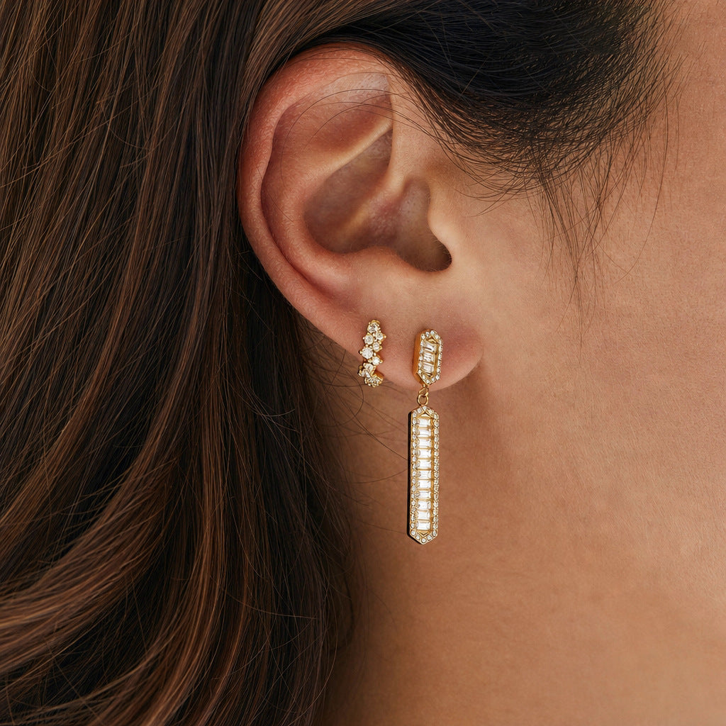 Long baguette-accent bar earring worn beside a small stud