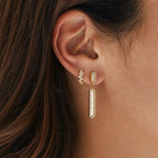 Long baguette-accent bar earring worn beside a small stud