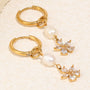 gold plated stainless steel pearl flower huggie earrings close-up