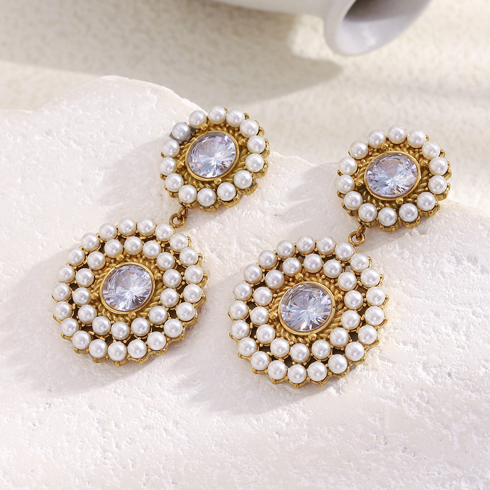 two-tier pearl and clear zirconia drop earrings on ivory fabric