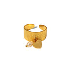 Front view of the heart charm and white bead on the open stainless steel ring