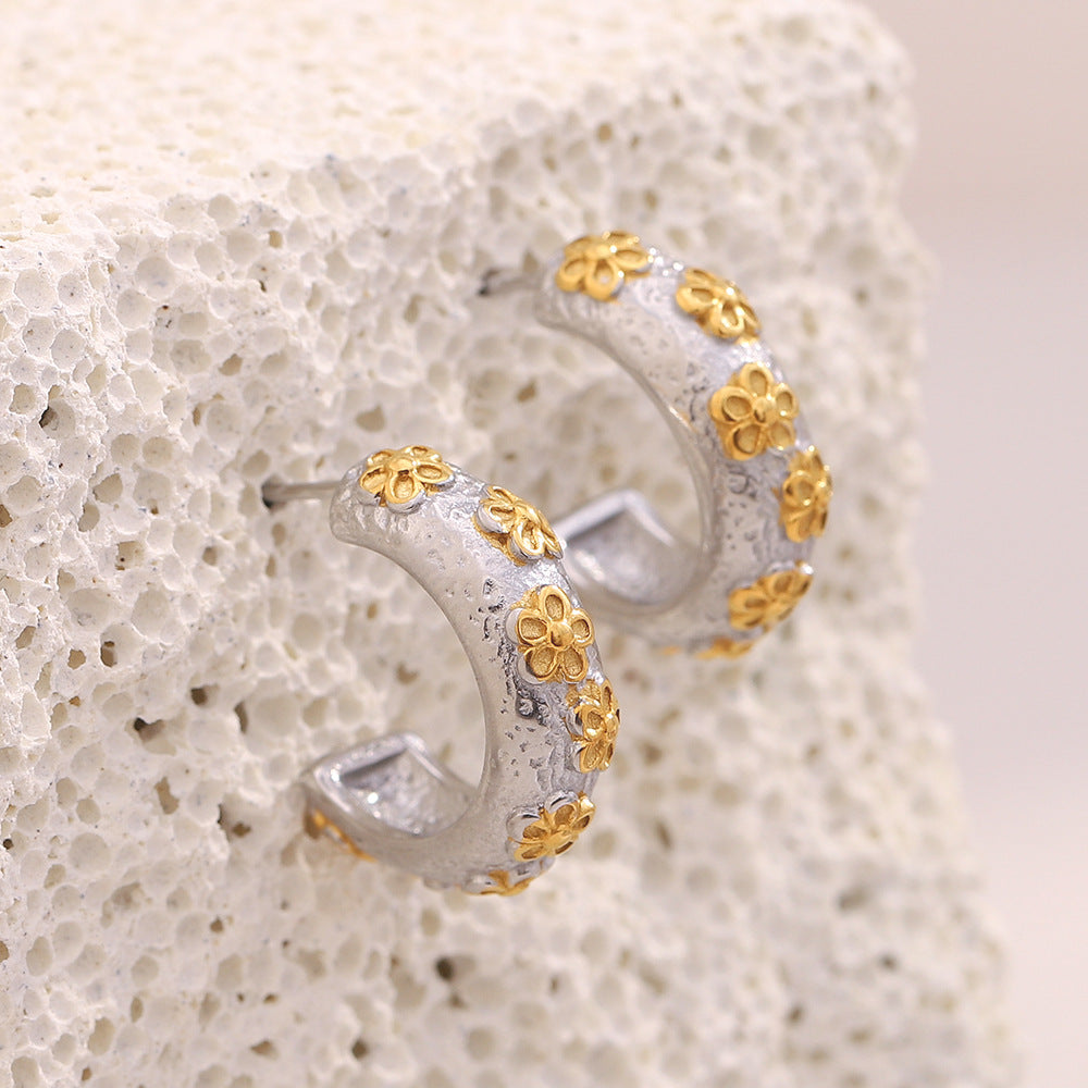 gold plated floral motifs on silver-finish C-hoop earrings