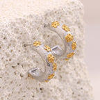 gold plated floral motifs on silver-finish C-hoop earrings