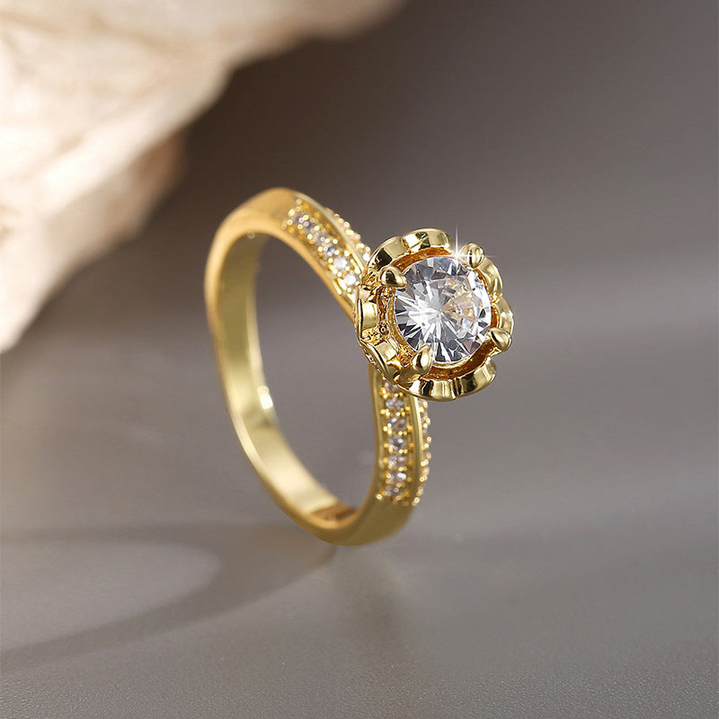 angled solitaire ring with scalloped setting and clear shoulders