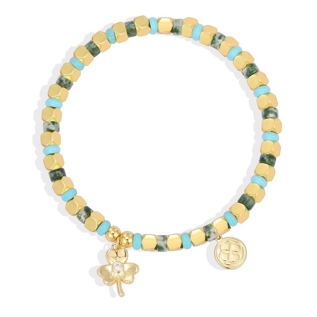 isolated clover charm bracelet with green blue and gold cube beads