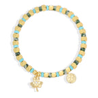 isolated clover charm bracelet with green blue and gold cube beads
