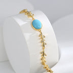 side view of botanical vine bracelet with oval blue center