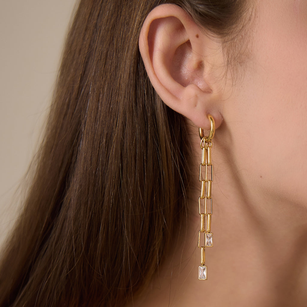 Long double link drop earring worn on an ear