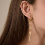 Long double link drop earring worn on an ear