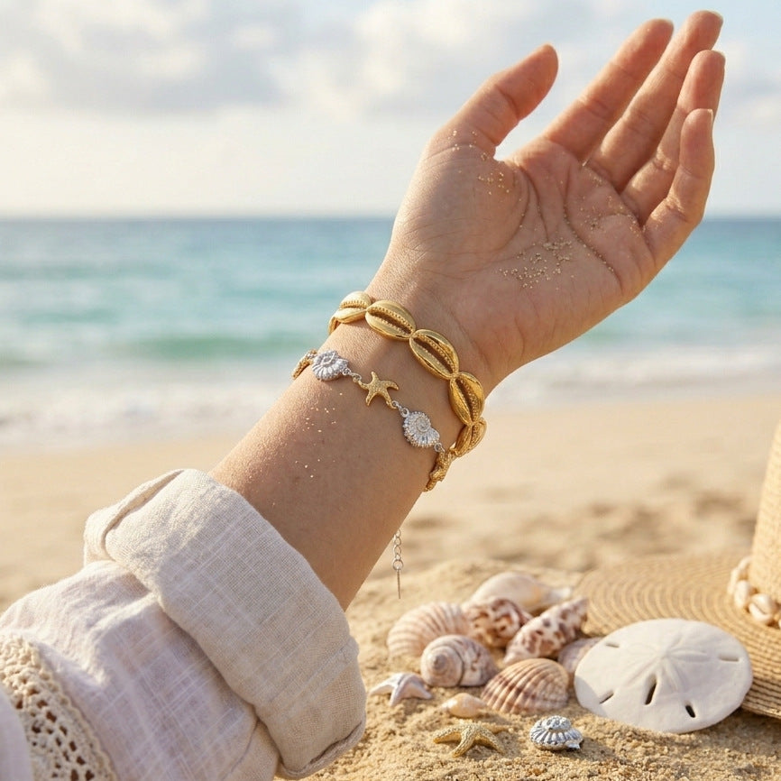 Coastal cuff and bracelet shown on wrist by the beach