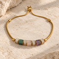 Gold plated 316L stainless steel bracelet with seven natural stone beads and an adjustable slider