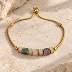 Gold plated 316L stainless steel bracelet with seven natural stone beads and an adjustable slider