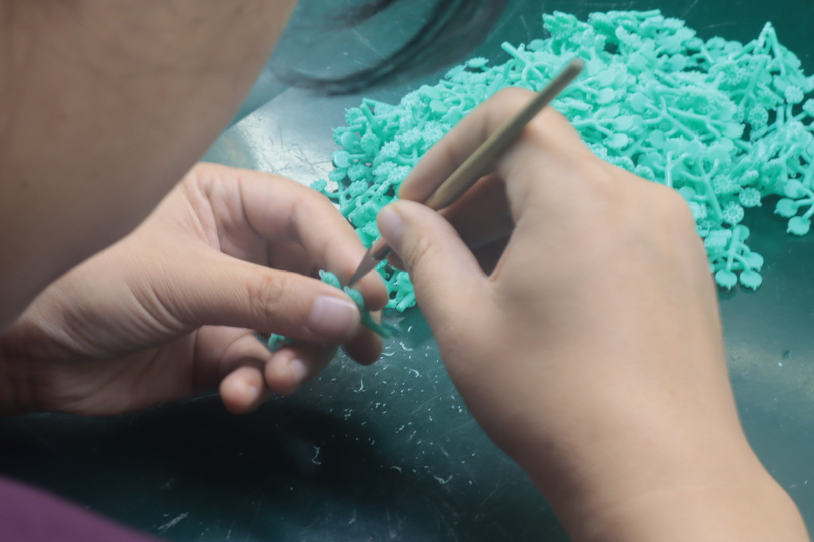 Fine wax jewelry models being trimmed during sample development