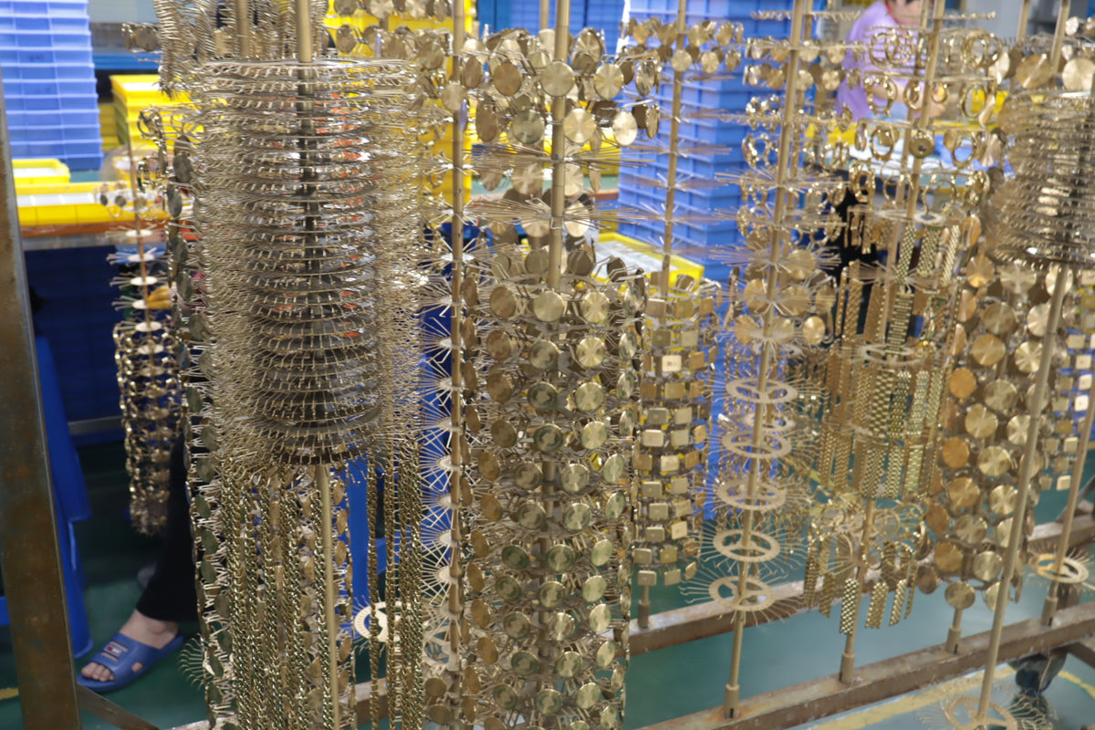 Jewelry components arranged on electroplating racks