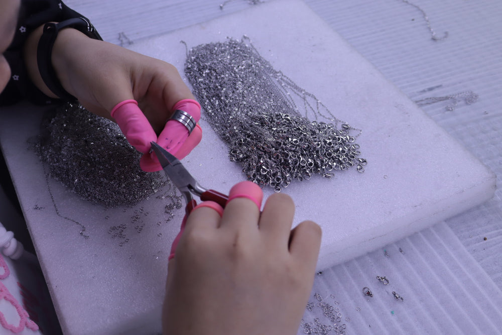 Jewelry chain being cut and prepared by hand