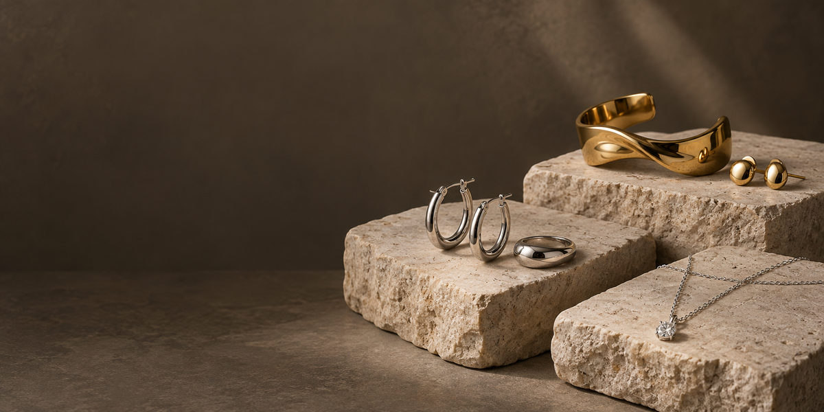 Gold-tone and silver-tone jewelry arranged on stone display blocks