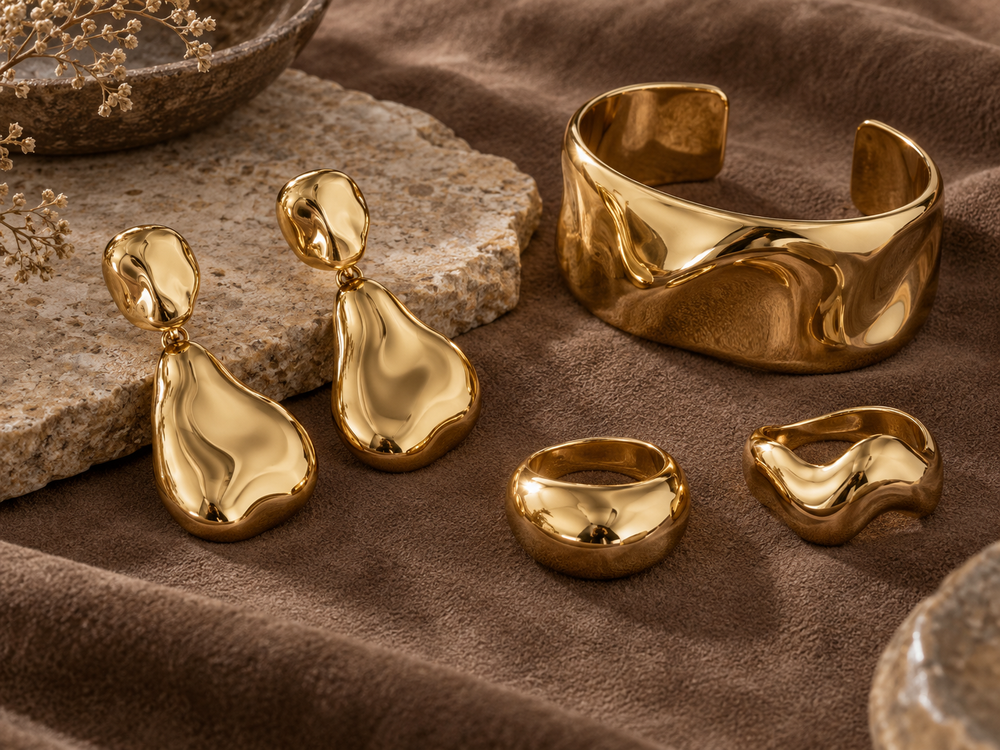 Sculptural earrings, chunky rings and a wide cuff
