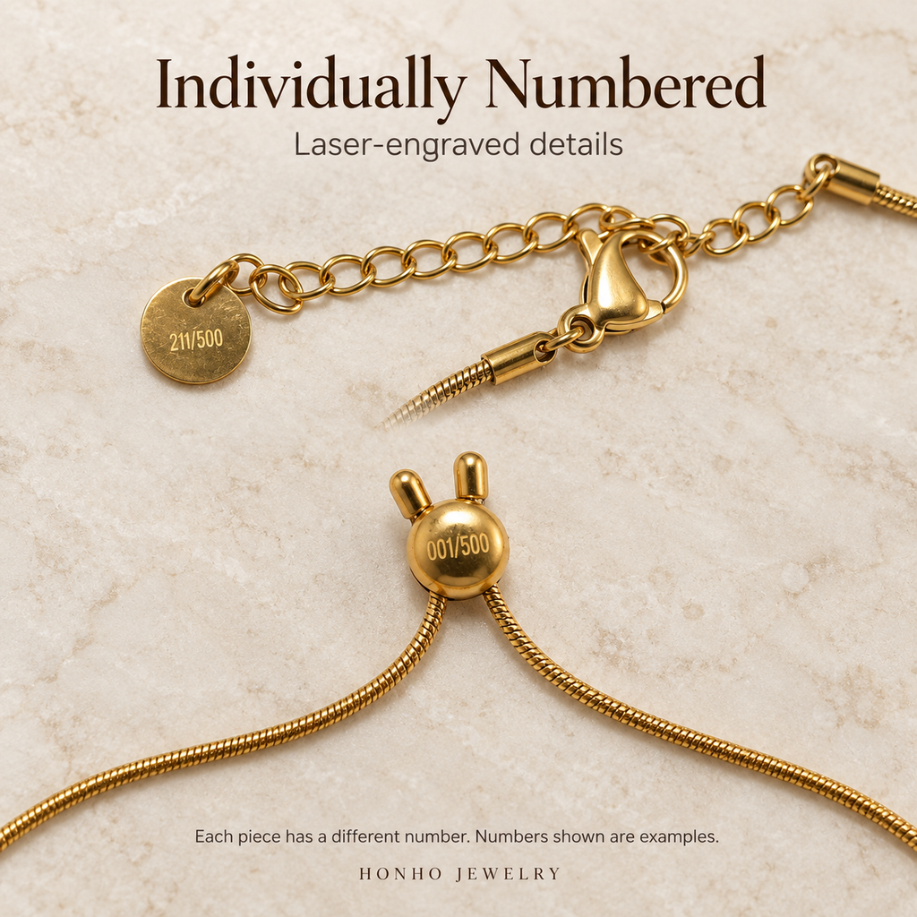 Close-up of different laser-engraved example numbers on the necklace tag and bracelet slider